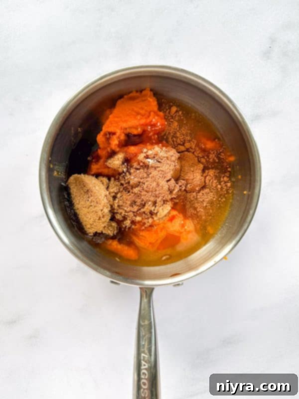 Ingredients for pumpkin butter combined in a saucepan, before cooking.