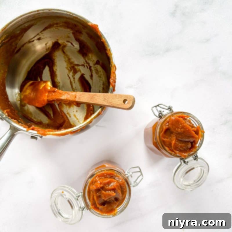 Finished pumpkin butter cooling in a saucepan after cooking.