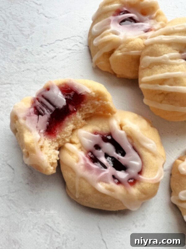 Almond Raspberry Shortbread Thumbprint Cookies on a white background, a delicious alternative to pumpkin.