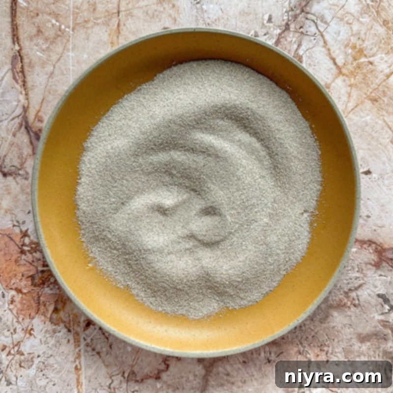 Chilling the snickerdoodle cookie dough in a bowl, a crucial step for perfect thumbprint cookies.