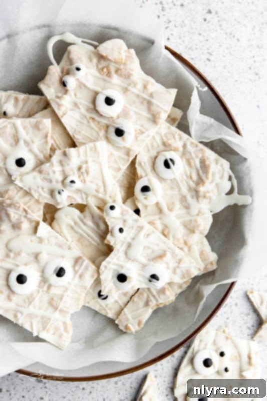 Close-up of Halloween Mummy Bark, white chocolate with crumbled Oreos and candy eyes.