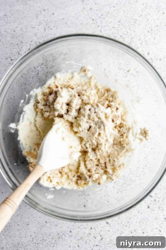 Step 5: Crushed Oreos and melted white chocolate being stirred together.