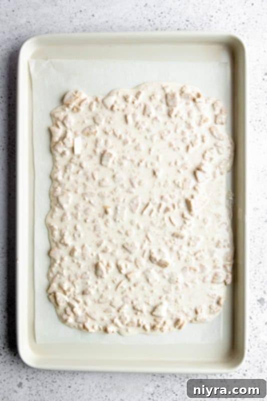 Step 6: Oreo and white chocolate mixture spread evenly on a parchment-lined baking sheet.