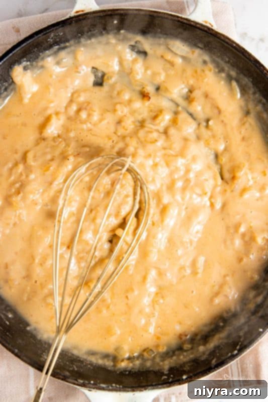 Simmering lemon sauce in a skillet.