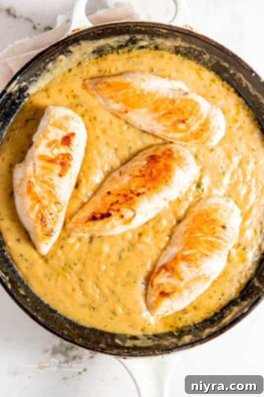 Finished lemon chicken in skillet, garnished.