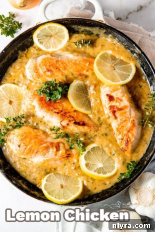 A beautifully plated lemon chicken dish with fresh herbs and lemon slices.