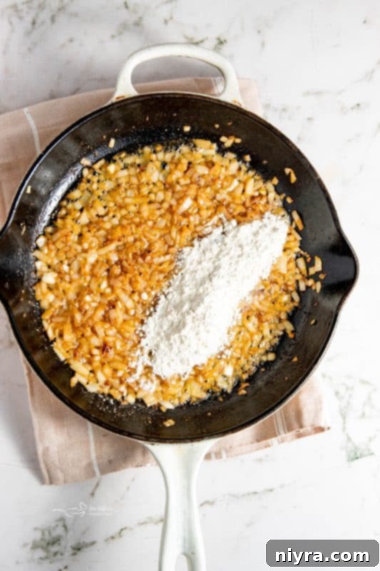 Flour added to skillet and whisked with aromatics.