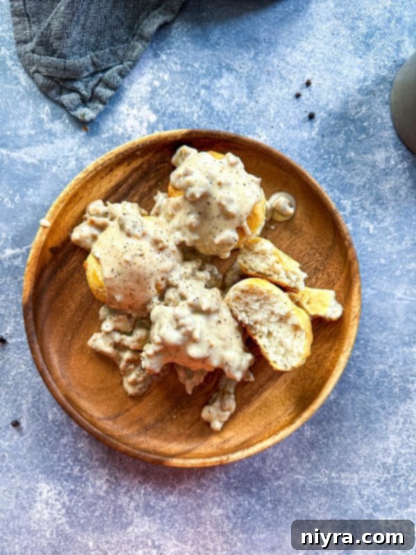 Rich, creamy homemade sausage gravy ready to be served over fresh biscuits, promising a delightful comfort food experience.