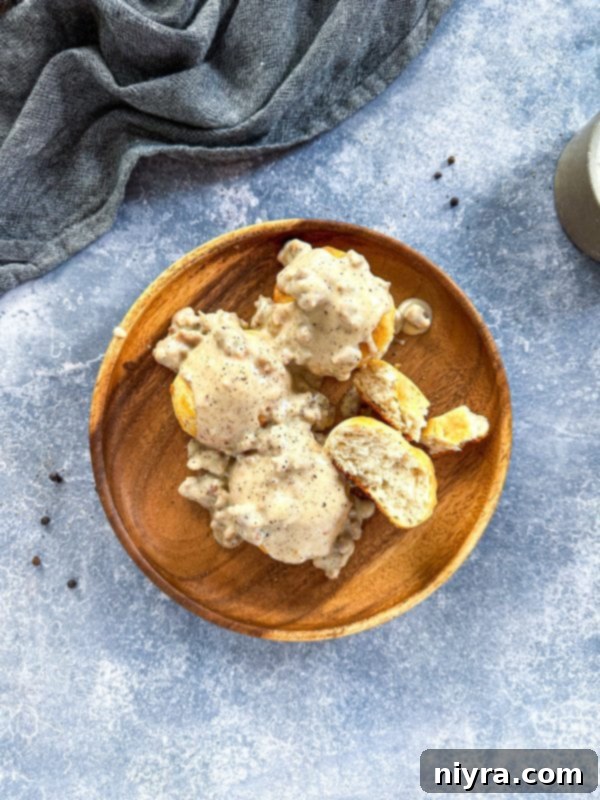 Finished sausage gravy in a skillet, seasoned and ready to serve, a truly comforting sight.