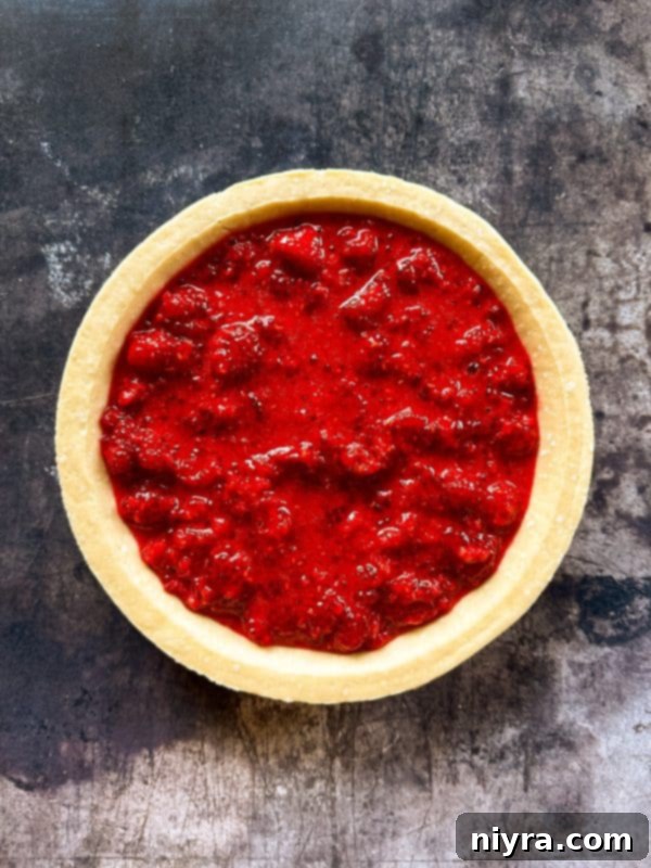 Tossing raspberries with lemon juice and dry ingredients