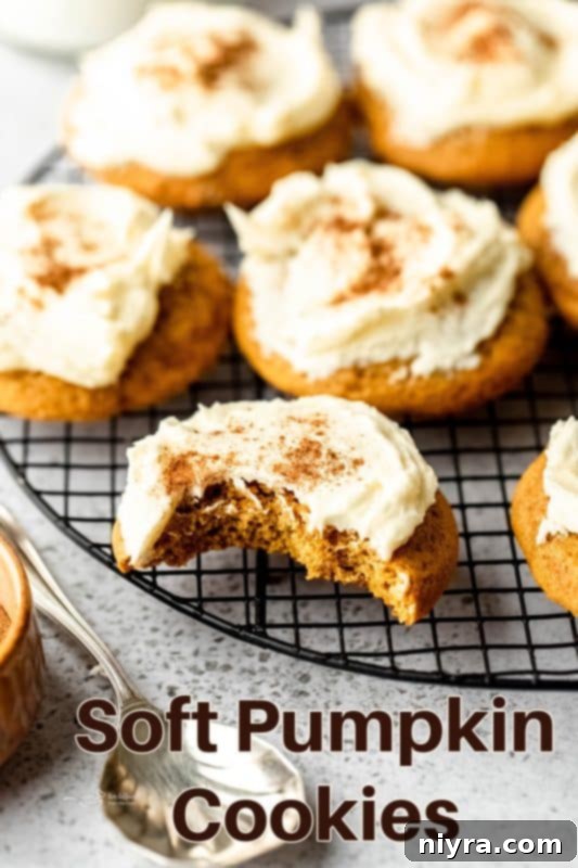Large batch of soft pumpkin cookies on a cooling rack