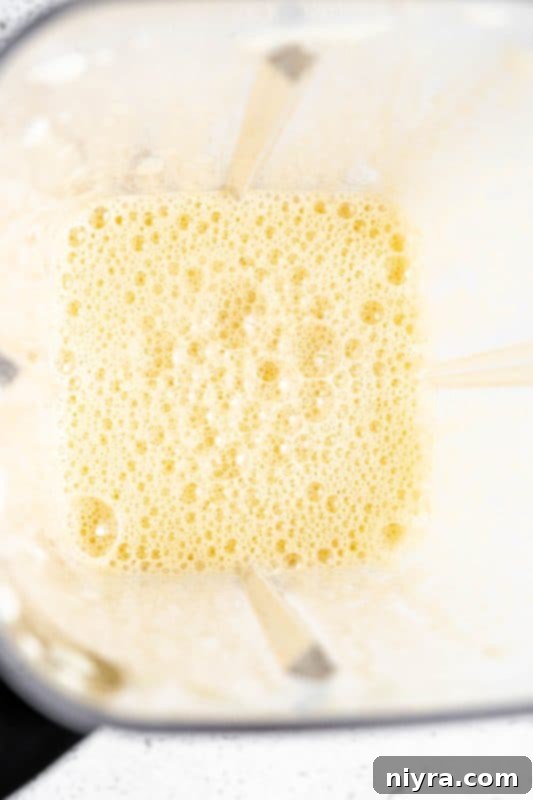 Homemade Blender Eggnog 9 Step 3: Blending eggs and maple syrup until light and frothy.