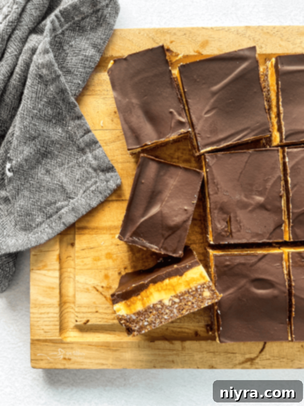 Chewy Coconut Macaroon Blondies 17 Classic Nanaimo Bars cut into squares on a wooden board