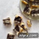 Chewy Coconut Macaroon Blondies 20 Coconut Macaroon Blondies on a plate and on a table