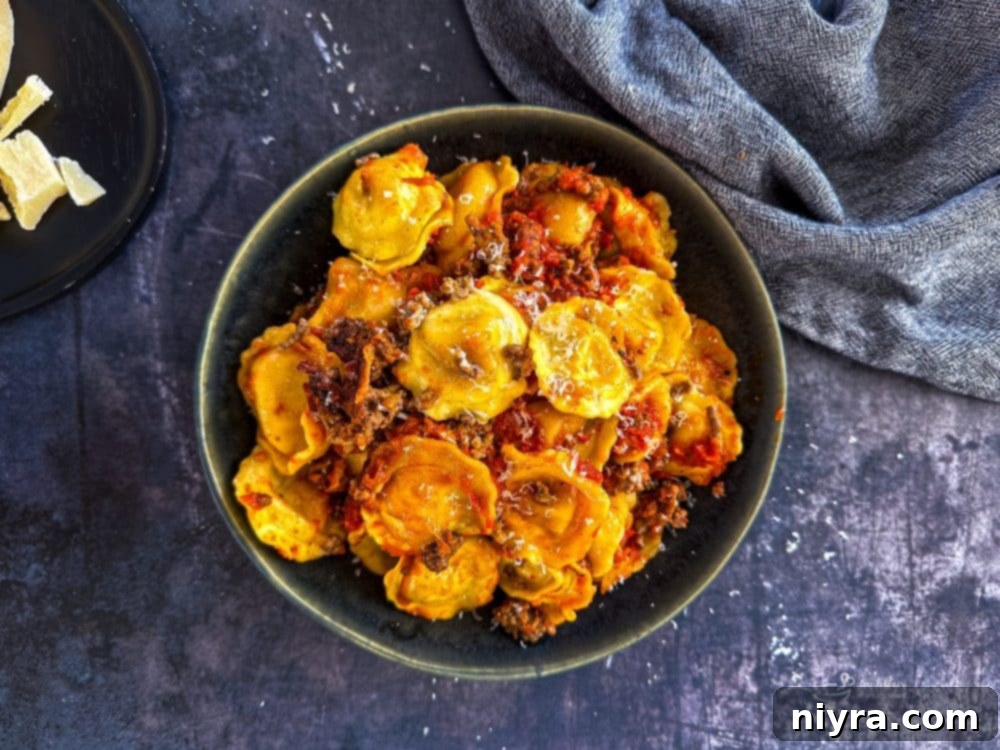Close-up of layers within the slow cooker ravioli lasagna, featuring pasta, meat, and cheese.