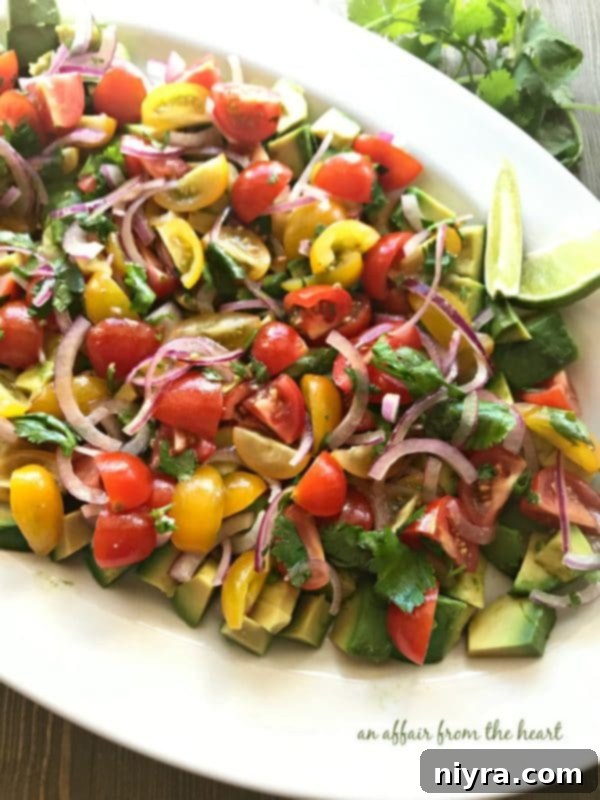 Layered Guacamole Salad 7 A serving of Deconstructed Guacamole Salad next to a glass of iced tea