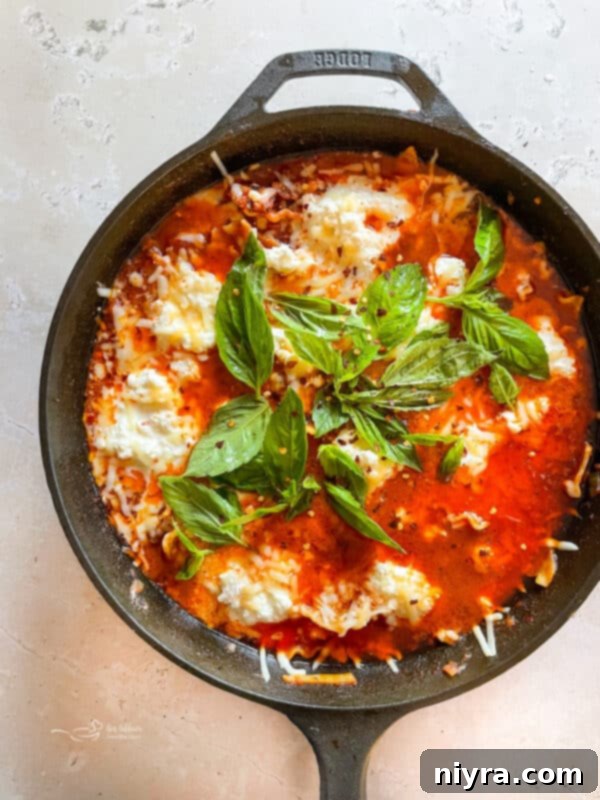 A close-up of skillet lasagna being served