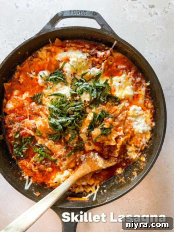 A large serving of Skillet Lasagna in a cast iron pan