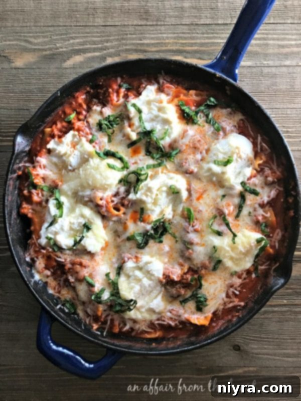 Overhead view of a cast iron skillet filled with lasagna