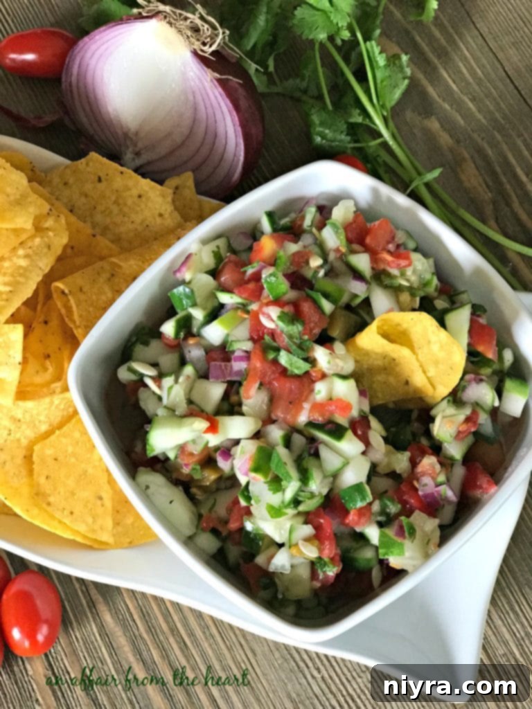 Overhead view of homemade cucumber salsa in a white serving bowl.