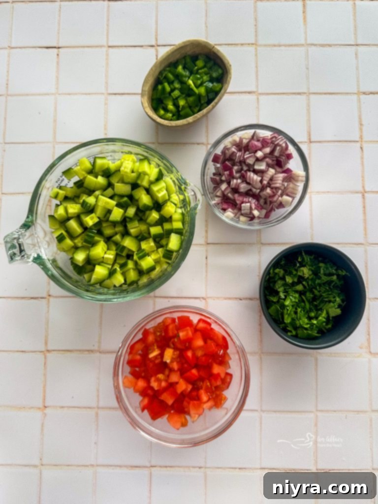 Ingredients for cucumber salsa laid out on a cutting board.
