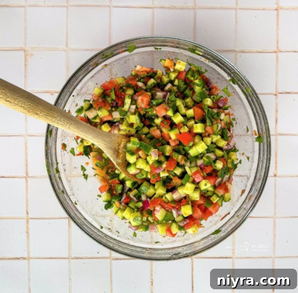 Close-up of cucumber salsa in a bowl after mixing all ingredients.