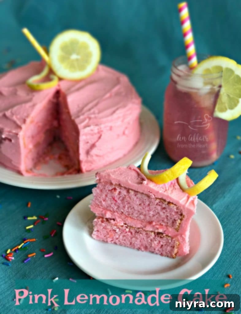 A large, beautifully decorated Pink Lemonade Cake on a elegant cake stand, with a single slice cut out and ready to be served, showing its delicious interior.