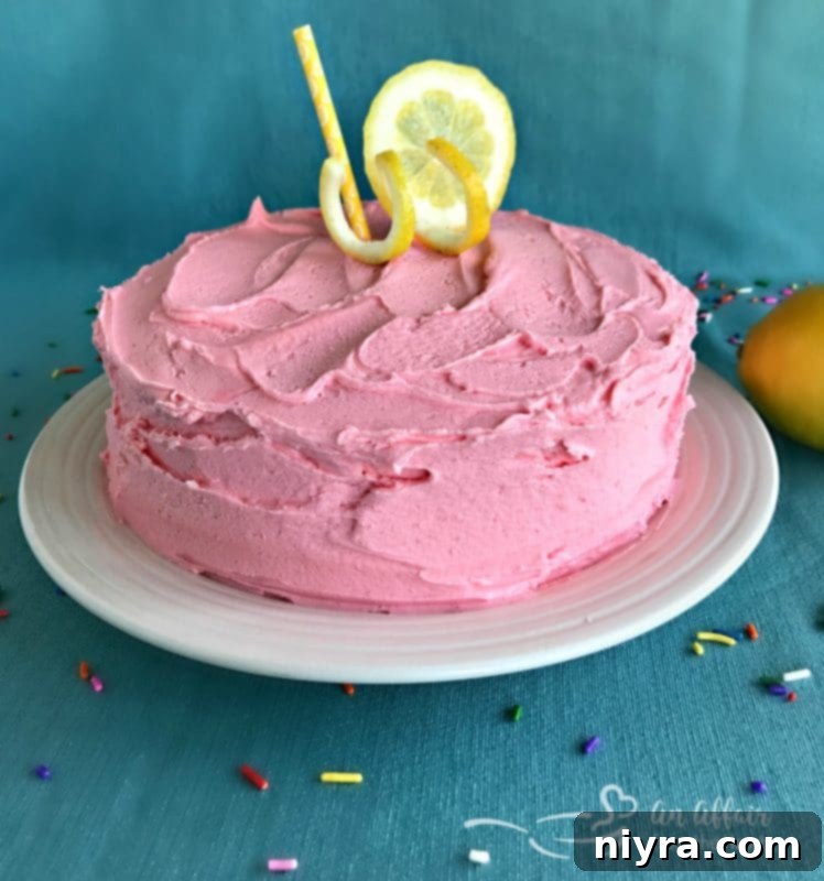 An elegant shot of the whole Pink Lemonade Cake, showcasing its vibrant color and festive appeal for any gathering or celebration.