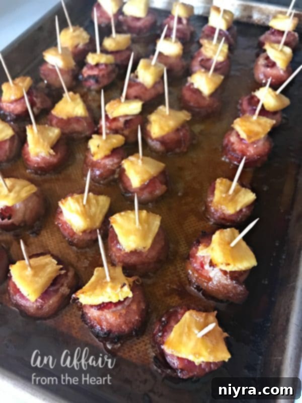 Baked Aloha Bacon Wrapped Sausage Bites with pineapple, ready to be enjoyed.