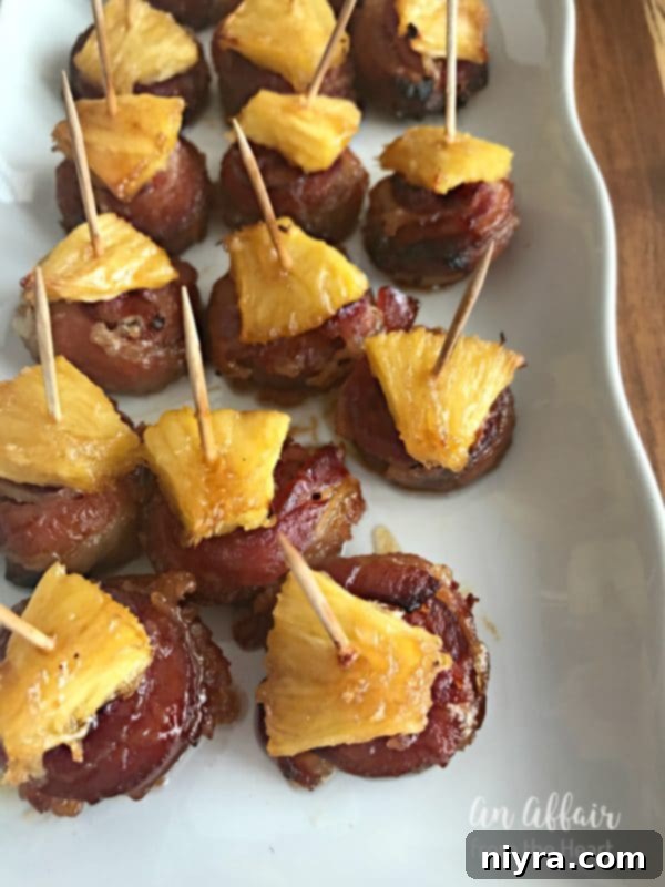 Assortment of Aloha Bacon Wrapped Sausage Bites arranged beautifully on a serving tray.