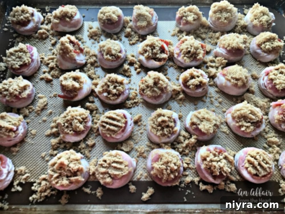 Brown sugar being generously sprinkled over the bacon-wrapped sausage bites.