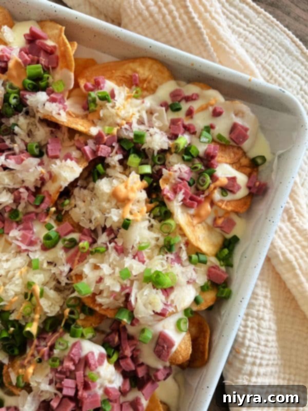 Reuben's Tangy Nacho Tower 2 Reuben Nachos on a baking sheet, garnished with scallions