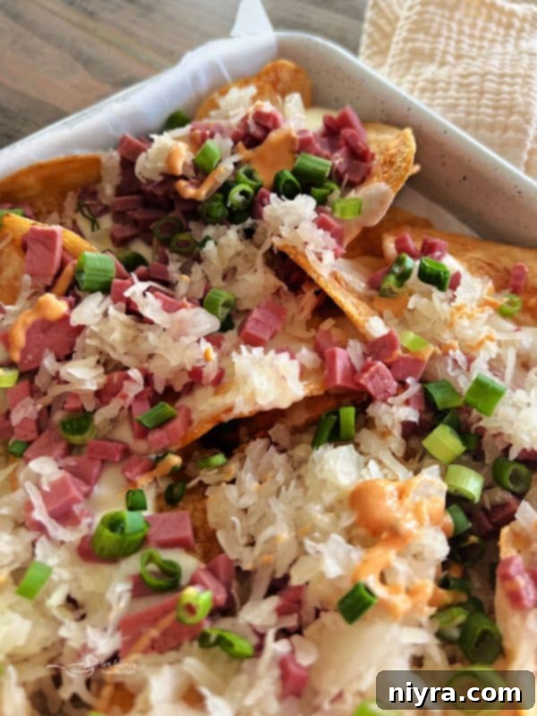 Reuben's Tangy Nacho Tower 15 Reuben Nachos served on a rustic wooden board
