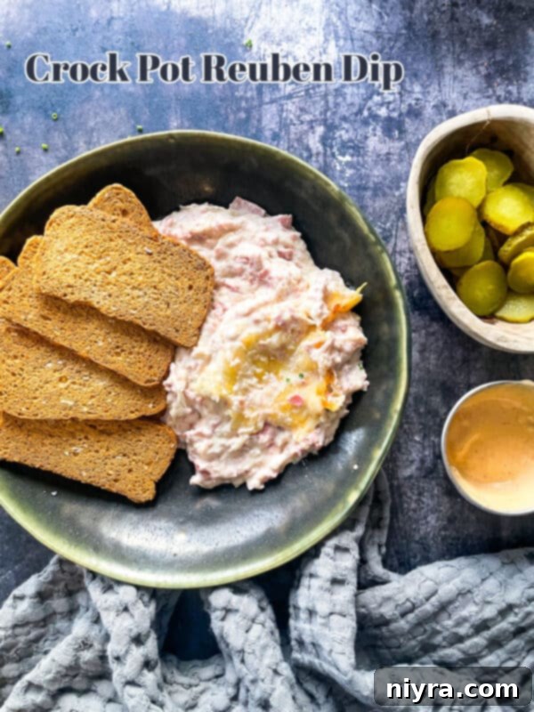 Reuben's Tangy Nacho Tower 17 Reuben dip and rye toast in a green bowl.