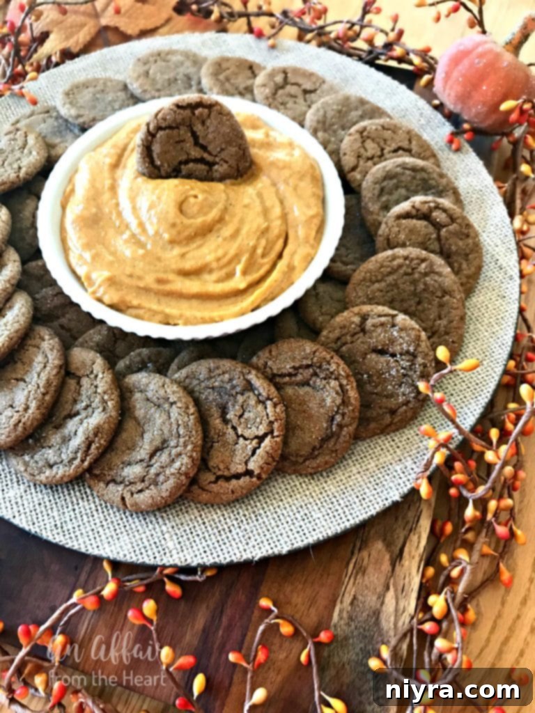 A bountiful display of spice cookies arranged around a pumpkin dip, highlighting their inviting appeal.