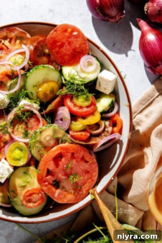 A vibrant bowl of Cucumber Tomato Salad with fresh ingredients.