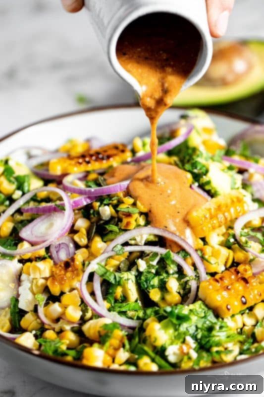 Close up of Grilled Corn and Avocado Salad in a large, white serving bowl.