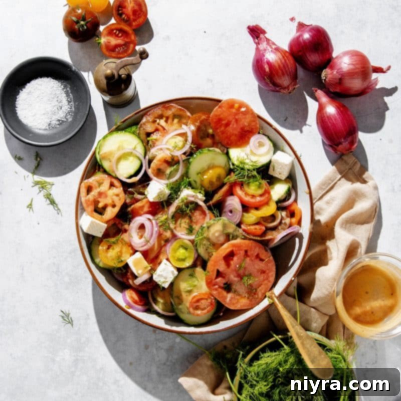 Close-up of a refreshing cucumber tomato feta salad in a glass bowl.