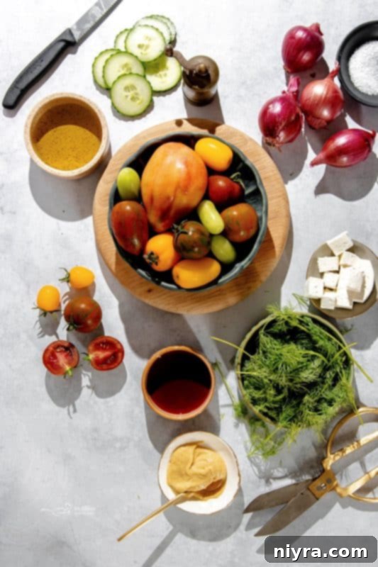 A large serving bowl filled with a fresh cucumber tomato and feta salad, ready to be served.