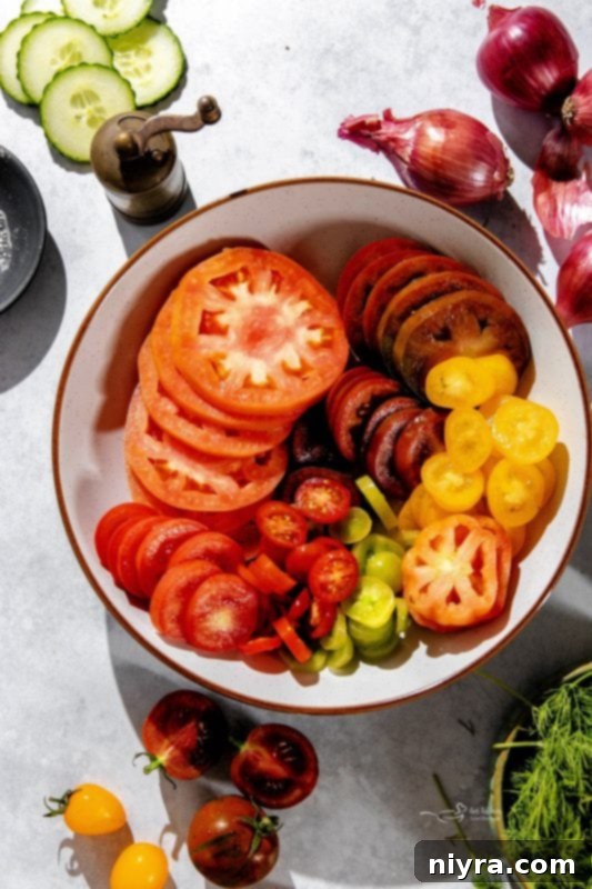 Freshly chopped dill and feta cheese scattered over a vibrant cucumber and tomato salad.