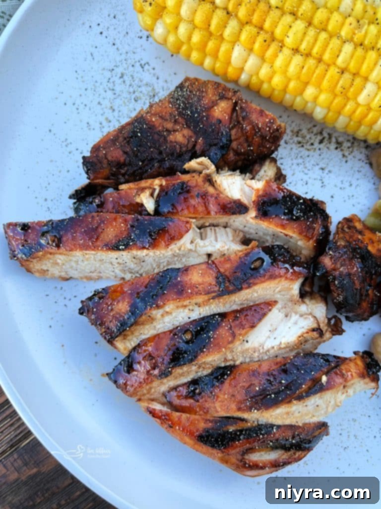 Sweet and Smoky Grilled Chicken, perfectly cooked on a barbecue, with a glistening, caramelized crust.