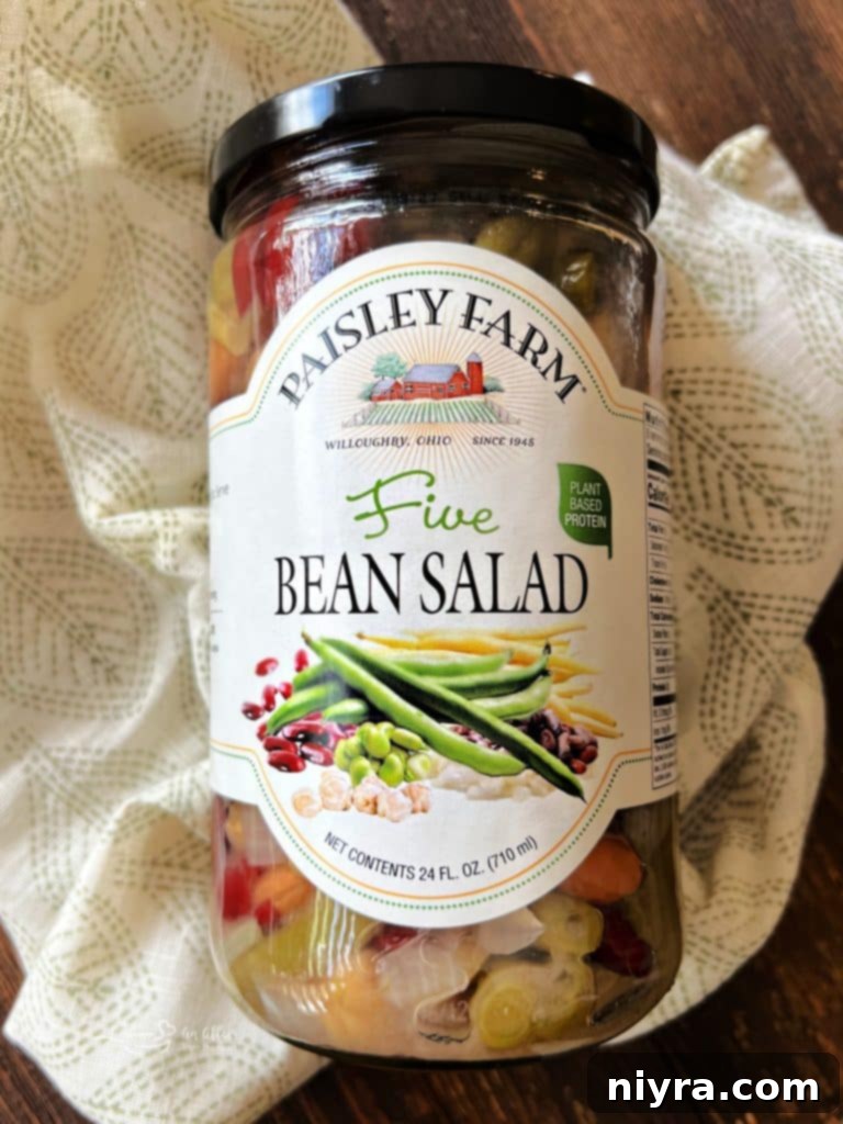 A jar of Paisley Farm Five Bean Salad prominently displayed.