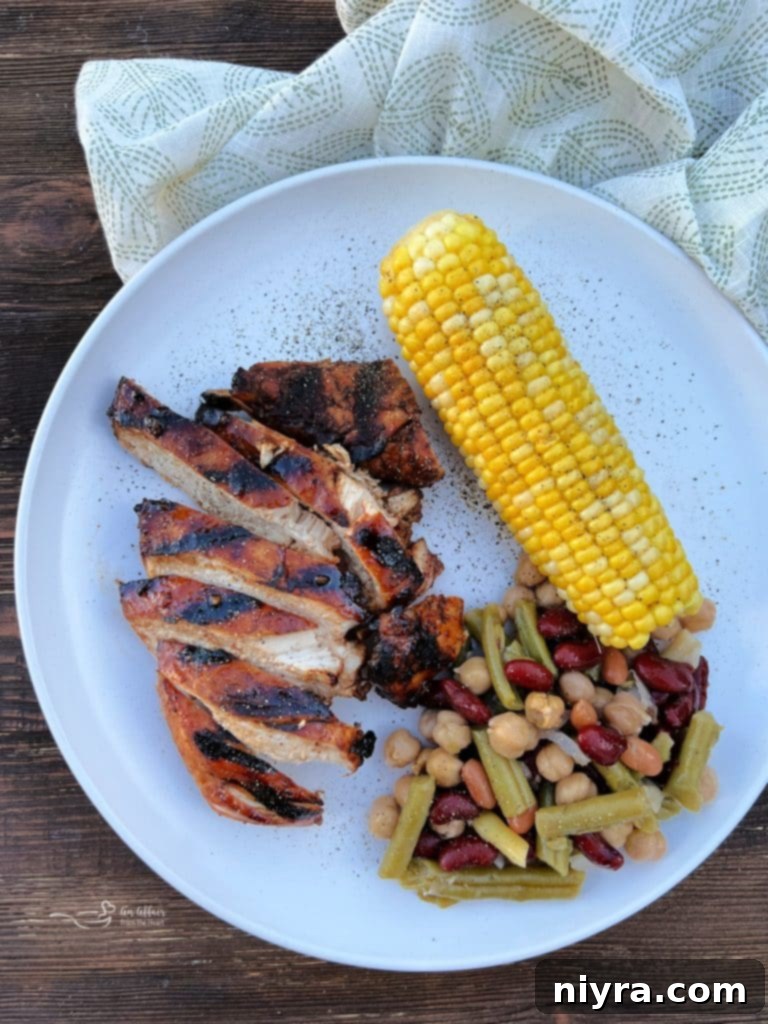 Another appealing shot of the Sweet and Smoky Grilled Chicken on a plate with the bean salad.