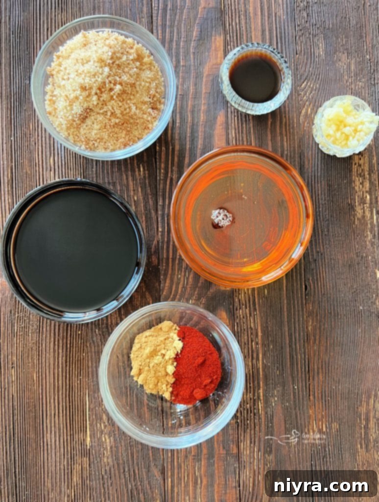 Four pieces of grilled Sweet and Smoky Chicken resting on a white platter, ready to be served.