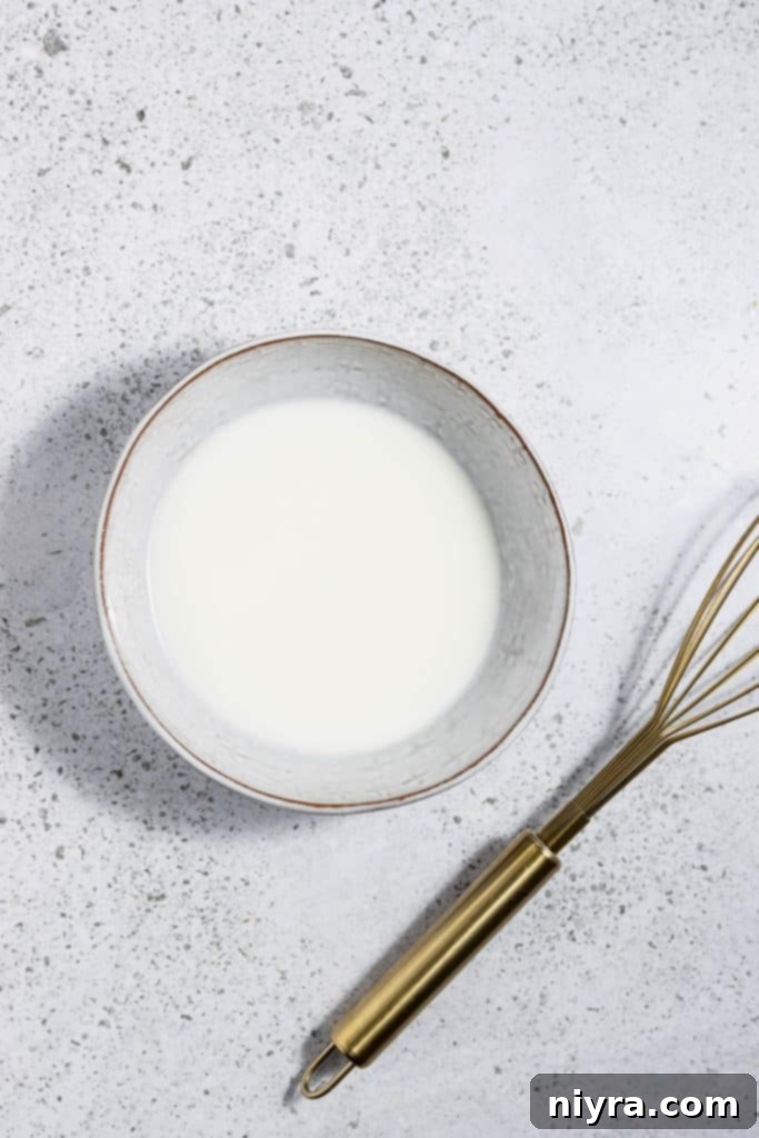 Easy Slow Cooker Chicken Marsala 10 Water and cornstarch being whisked together in a small bowl to create a slurry.