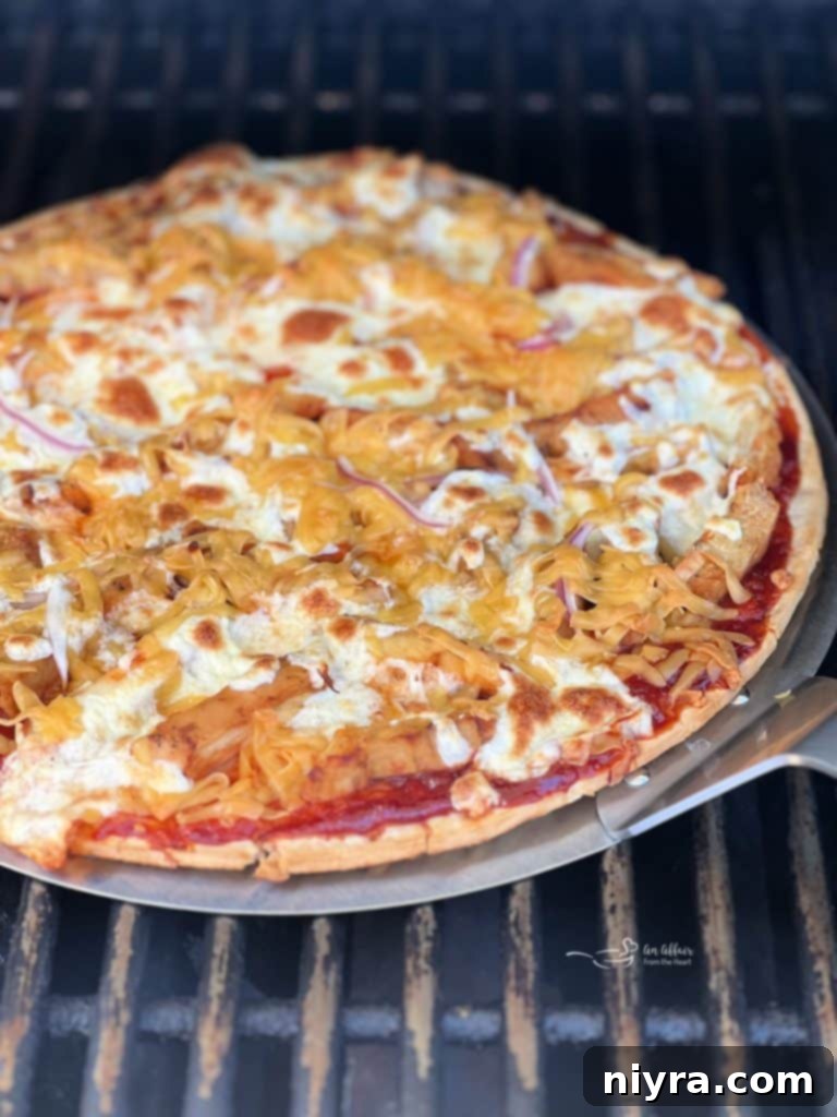 Fully topped BBQ Chicken Pizza before grilling.