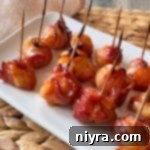 Dorothy's BBQ Bacon wrapped Water Chestnuts on a white serving platter.