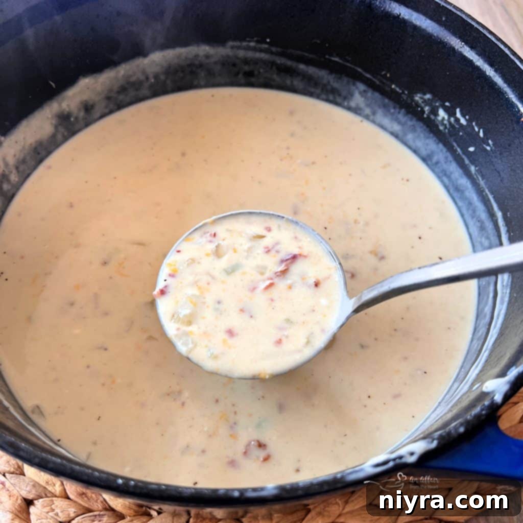 A Pinterest-optimized image featuring a bowl of creamy bacon soup with text overlay, encouraging users to pin the recipe.