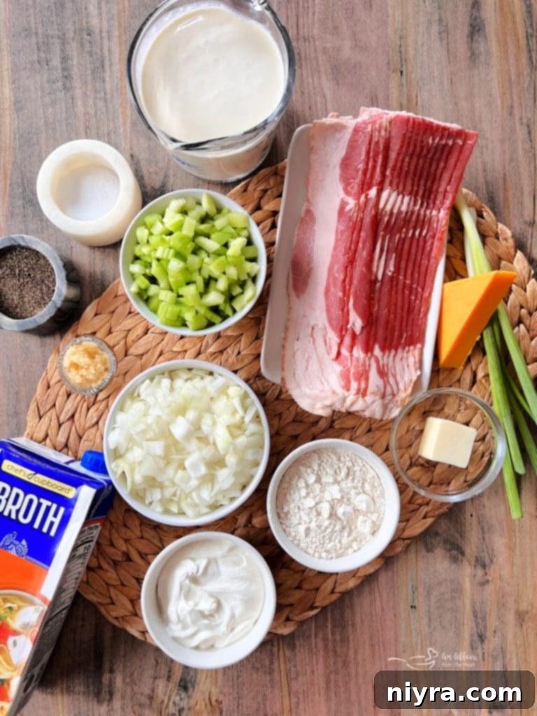 An overhead shot of a bowl of creamy bacon soup garnished with fresh green onions and crispy bacon bits.