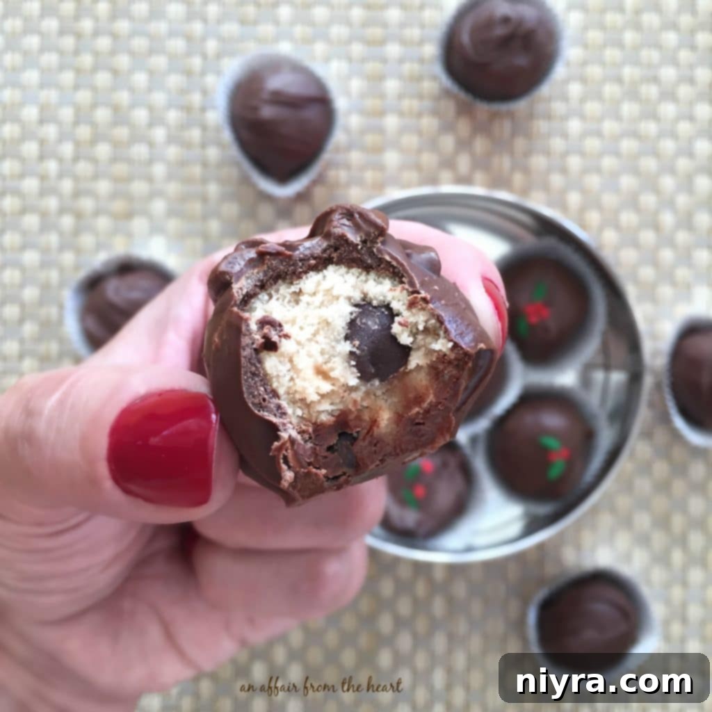 Close up of a Peanut Butter Chocolate Chip Cookie Dough Truffle with a bite out of it
